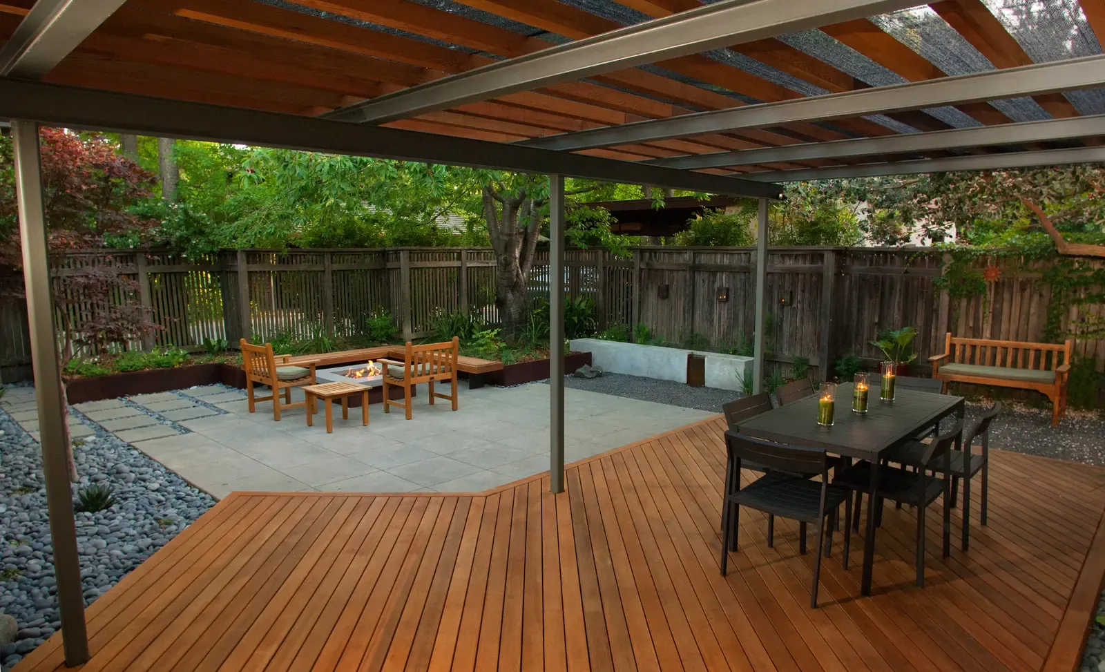 Dining table and lounge seating under the timber pergola, ipe deck in front