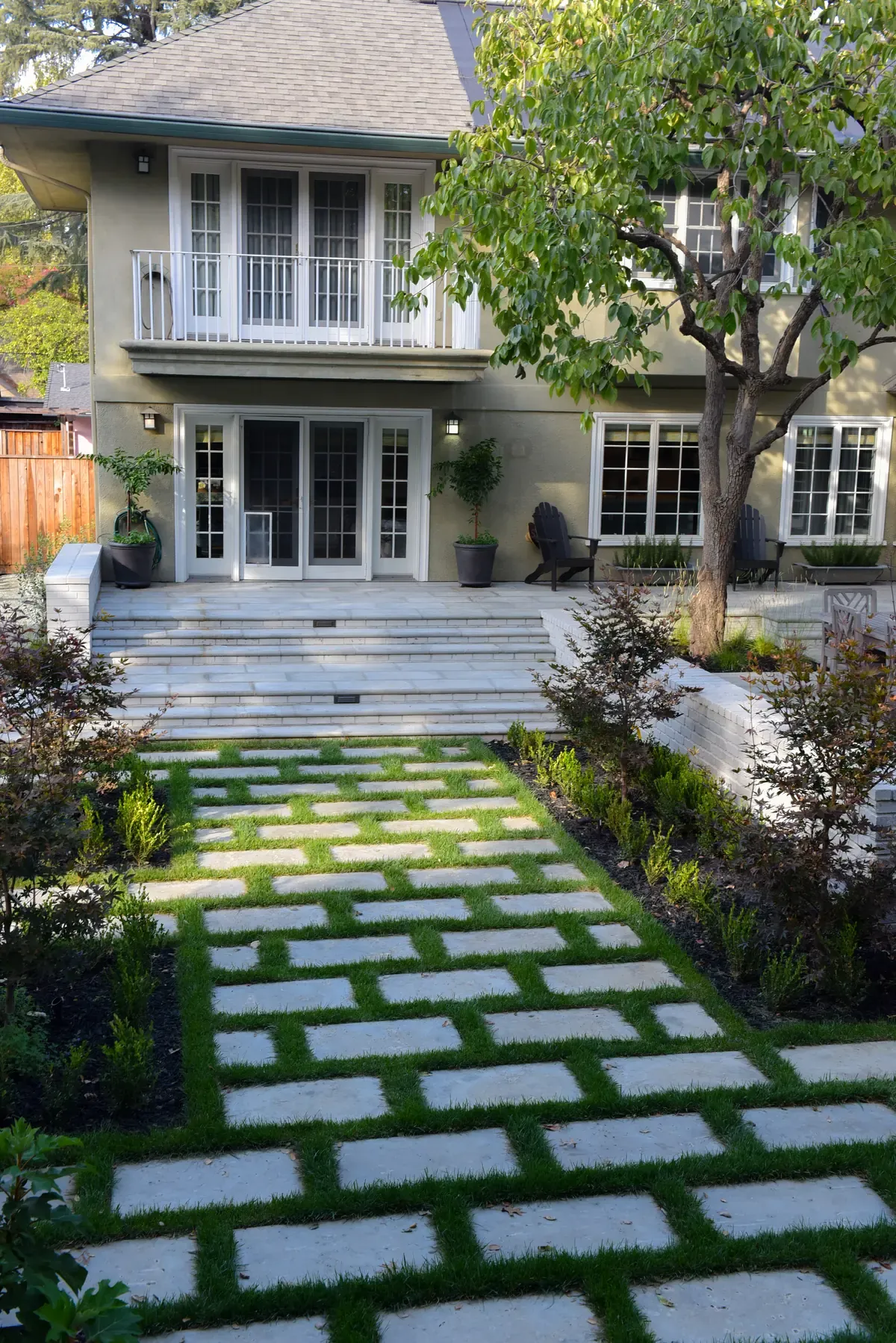 Pavers and grass joints forming a path to the steps at the front of the house