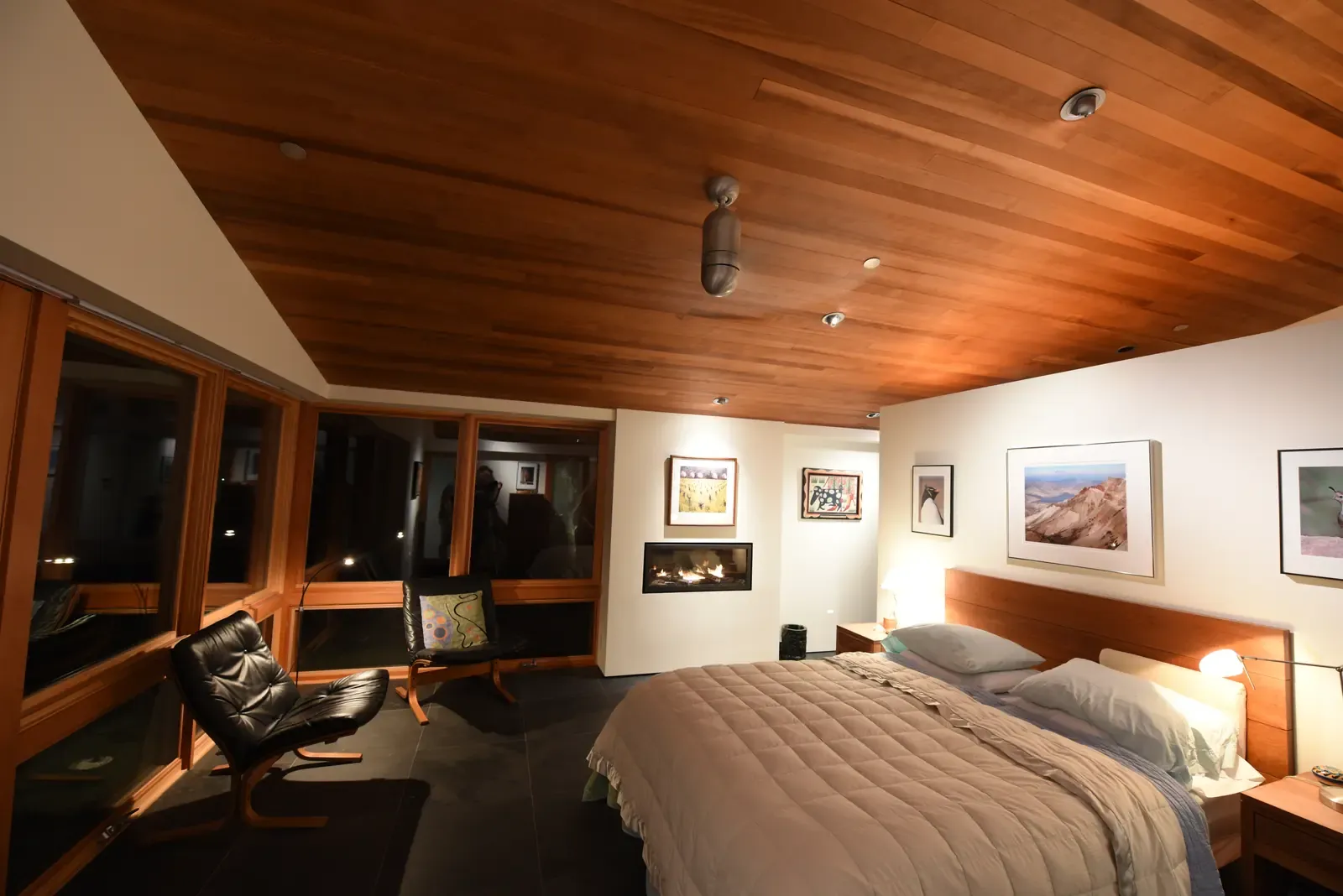 Bedroom opening to the window wall, fireplace at the corner