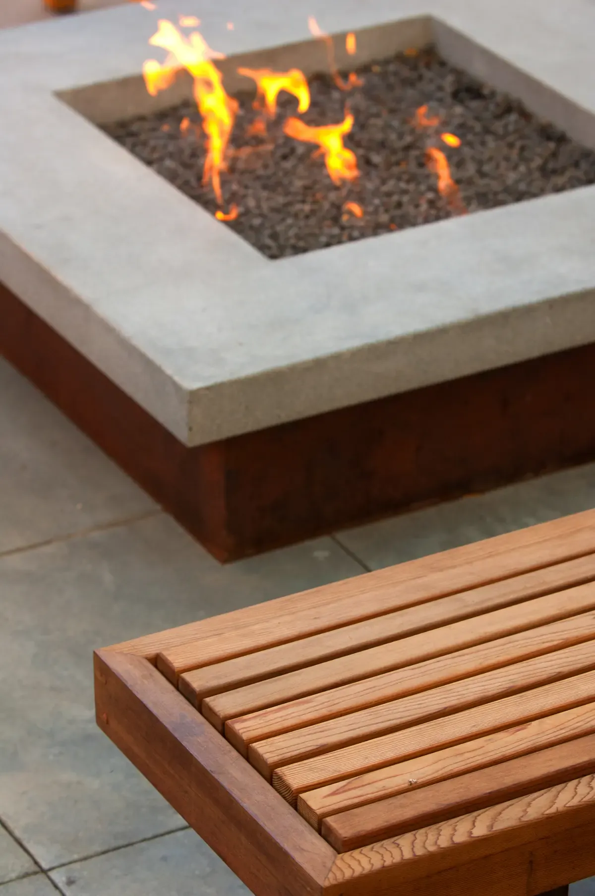 Fire alight in the concrete fire pit, ipe bench alongside