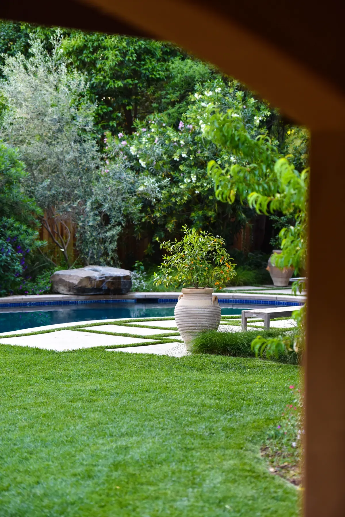 View through the arbour to the pool and lawn