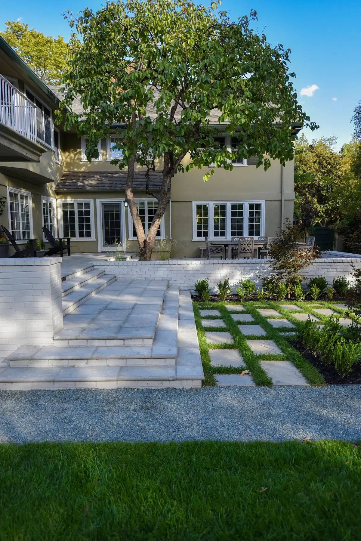 Broad stone steps rising from the lawn to the terrace