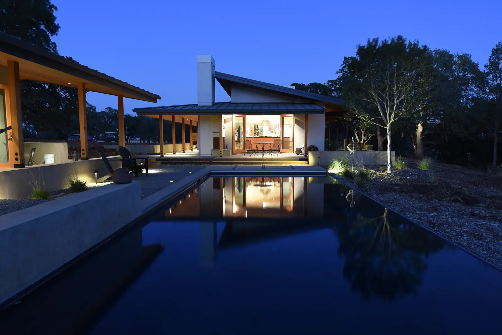 The house at dusk, mirrored in the lap pool