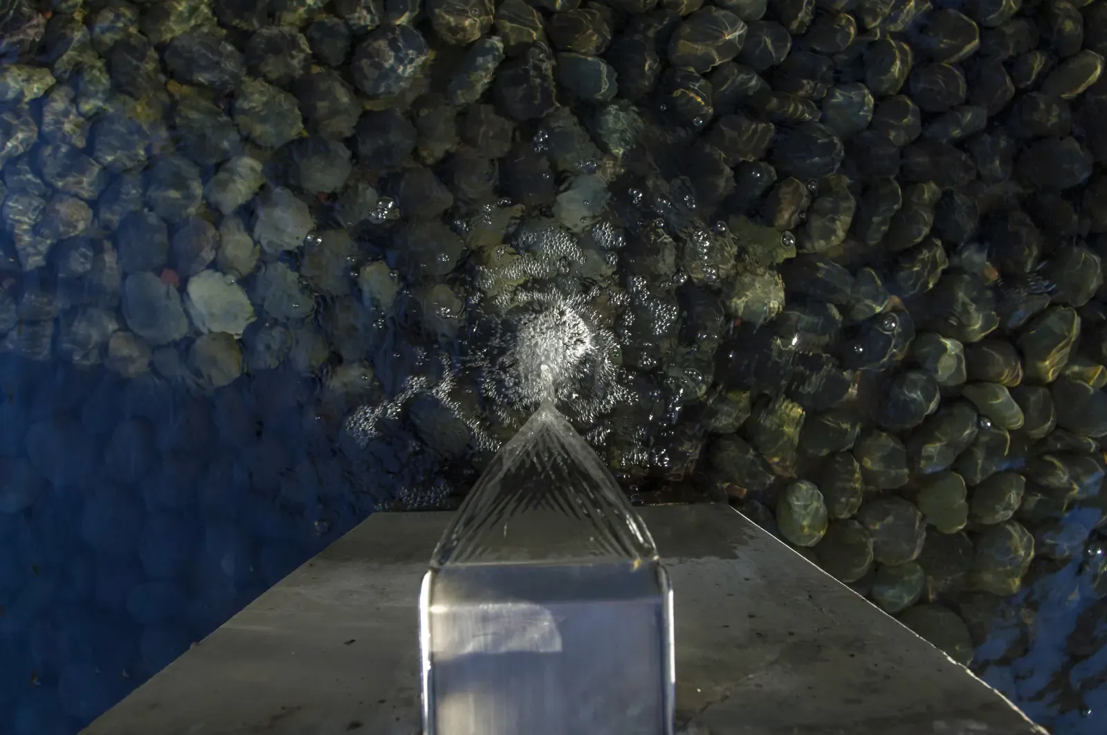 Close view of a fountain jet breaking on the cobble below