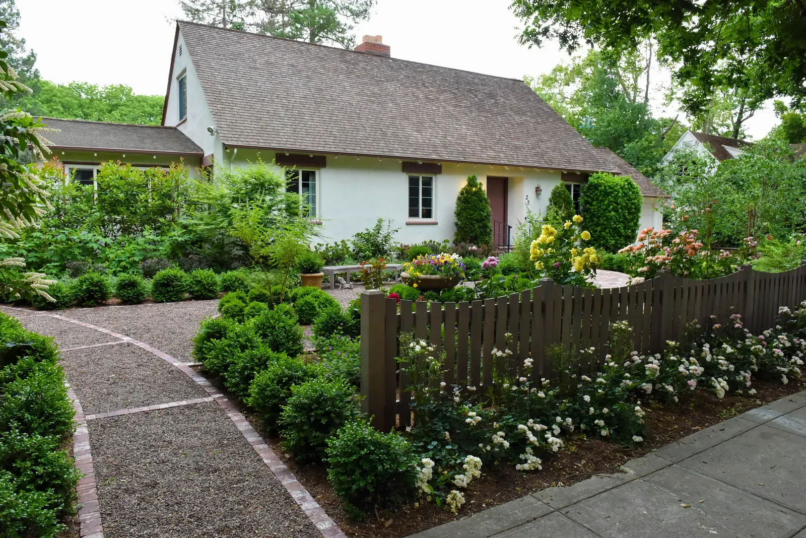 The house behind the fence, gravel path running along the frontage