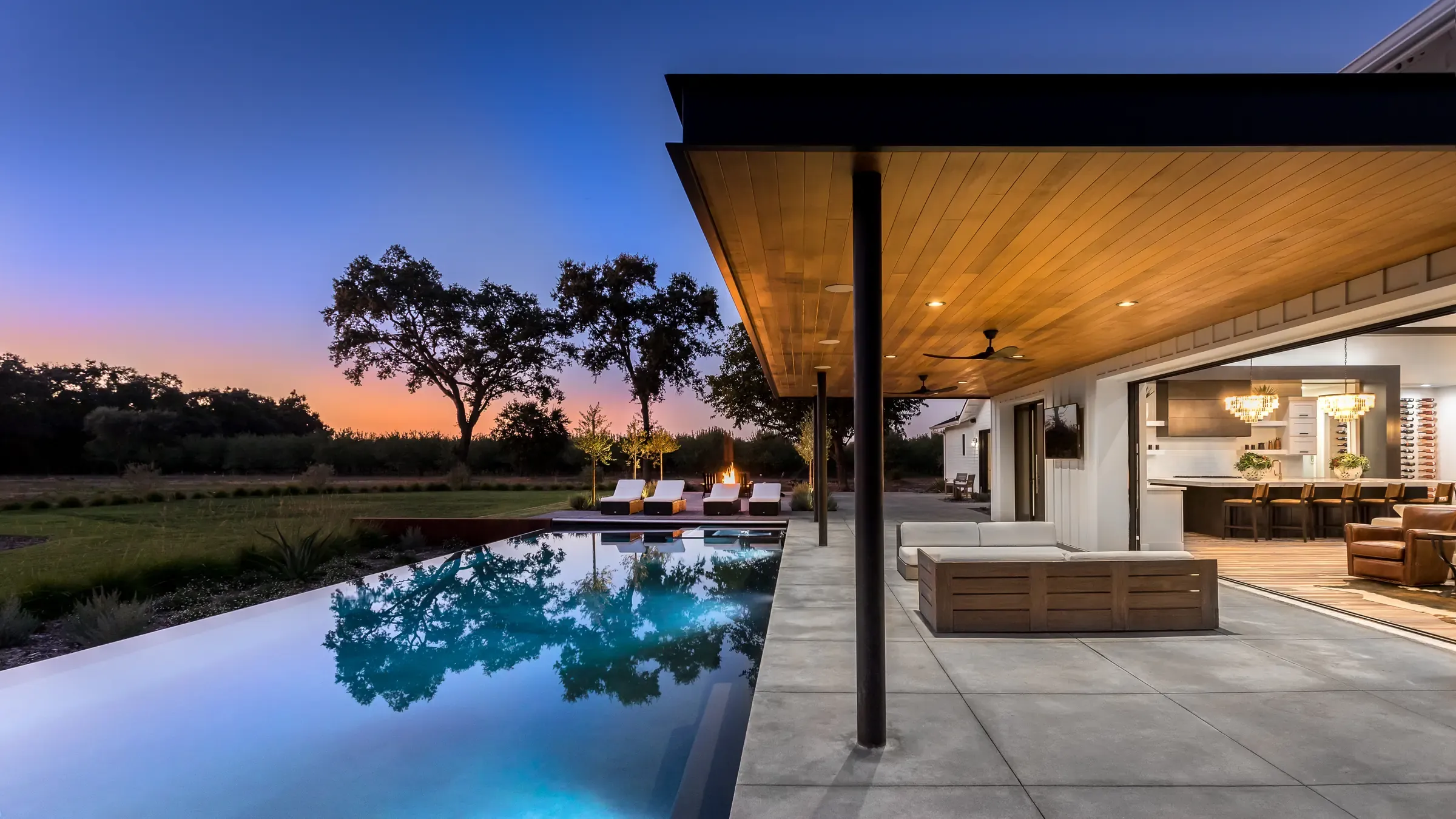 The terrace at sunset, pool holding the last of the sky