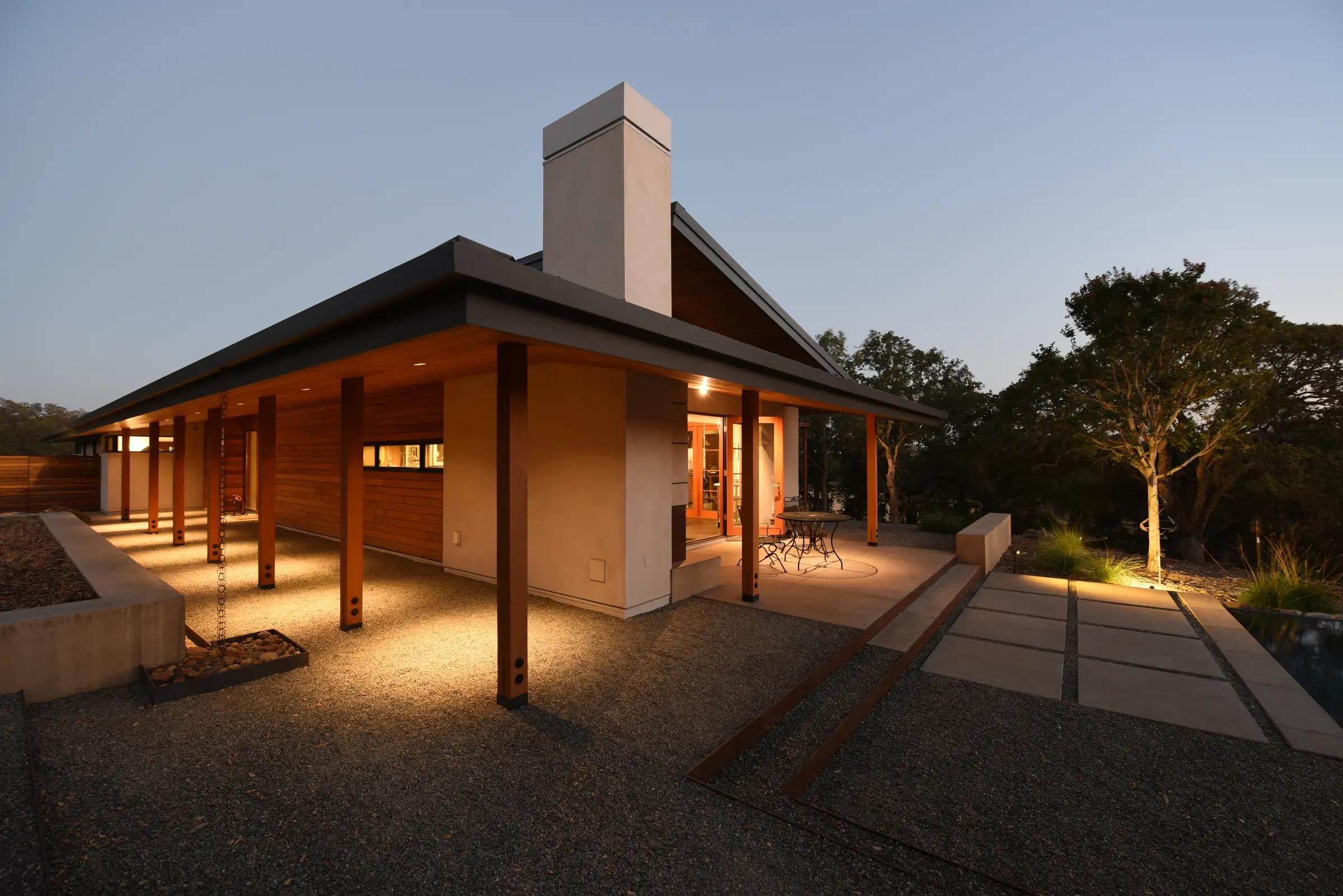Covered walkway and chimney lit at dusk